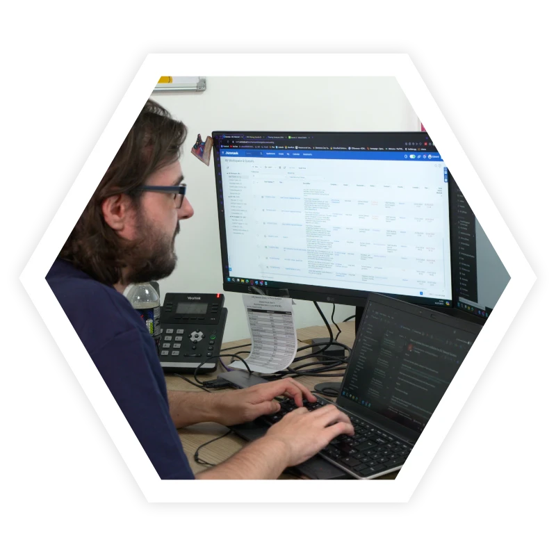 Working through databases on computer using laptop to navigate